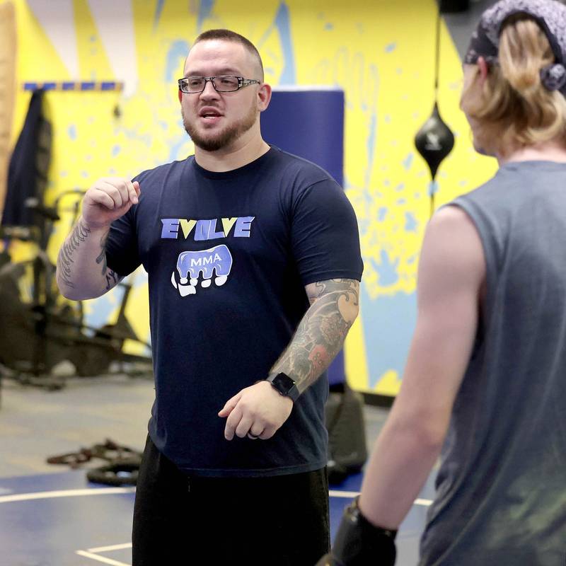 Joe Judkins, (left) head coach at Evolve MMA and Powerlifting, gives some instruction during a class Thursday, Nov. 9, 2023, at the facility in DeKalb.