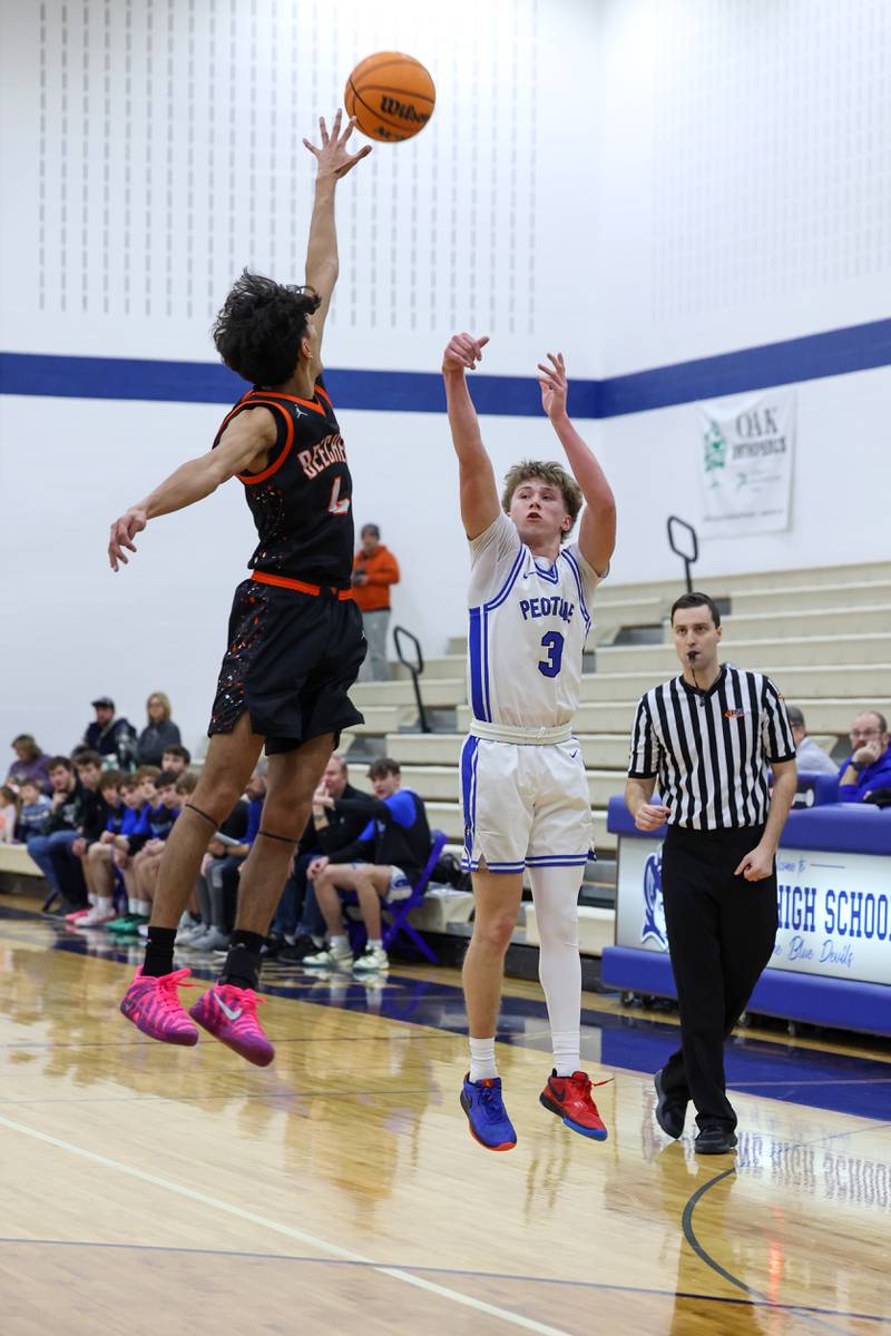 Peotone's Nick Cronin shoots a 3-pointer under pressure from Beecher's Wences Baumgartner during the Blue Devils' 64-52 victory over Beecher on Wednesday, Jan. 28, 2026.