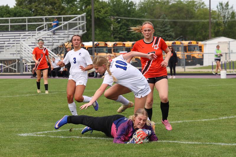 Beecher goalkeeper Mikenna Burdick dives on the ball ahead of Peotone's Bailey Logan (10) during Peotone's 2-1 victory over Beecher in the Class 1A Manteno Regional championship on Friday, May 22, 2026.