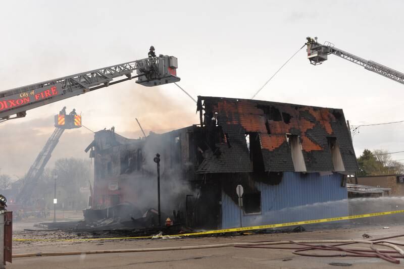 Firefighters from several departments responded to a structure fire at the corner of Main Street and Wesley Avenue in downtown Mt. Morris on Tuesday, April 16, 2024. The wooden structure housed two apartments and Sharky's Sports Bar. Fire crews battled high winds during the afternoon blaze.