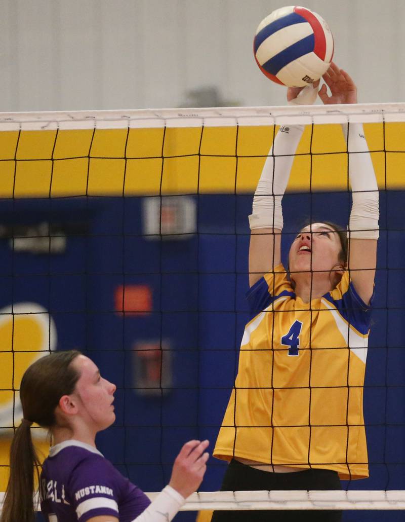Logan's Lenora Hopkins reaches up to block a spike from Rockford-Marshall's Ryley Vass during the IESA Class 3A eighth-grade Regional final game on Thursday, March 13, 2025 at Logan Junior High School in Princeton.