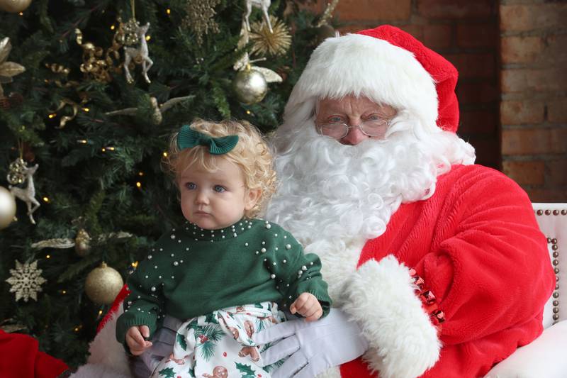 Santa Claus holds Ivory Hassler of Utica,  during the Miracle on First Street at the Auditorium Ballroom on Saturday, Dec. 6, 2025 in La Salle.