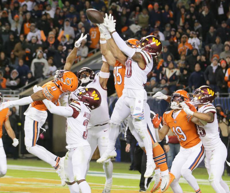 Chicago Bears tight end Cole Kmet (85) and Washington Commanders safety Bobby Mc Cain fail to catch the ball during the last play of the first half on Thursday, Oct. 13, 2022 at Soldier Field.