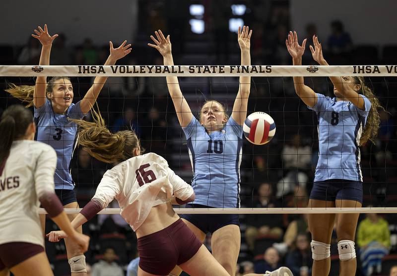 DePaul College Prep's Ava Wilson (left), Layla Christian and Amira Boone work the net against Prairie Ridge Saturday, Nov. 16, 2024, in the Class 3A third place state volleyball match at CEFCU Arena in Normal.