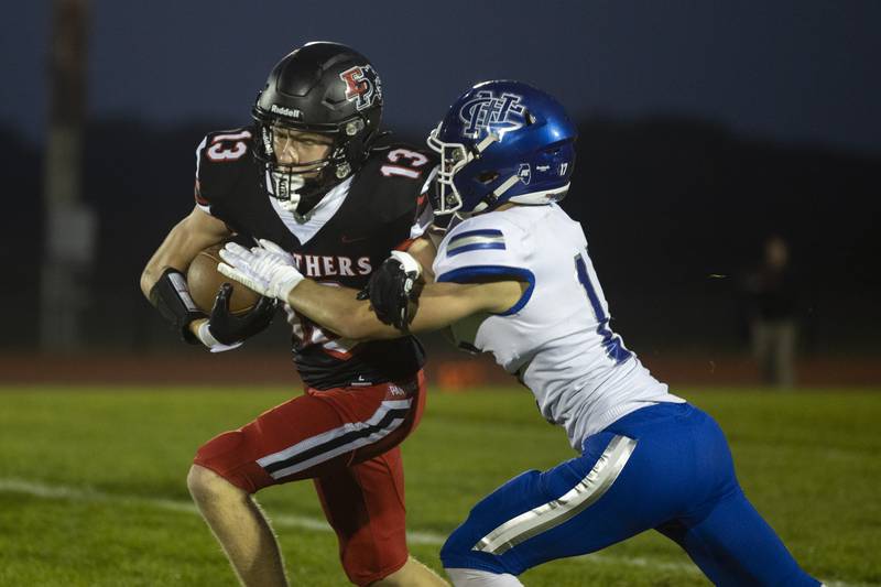 Erie-Prophetstown’s Connor Keegan picks up yards against Newman’s Mac Hanrahan Friday, Sept. 22, 2023 in a game at Erie.