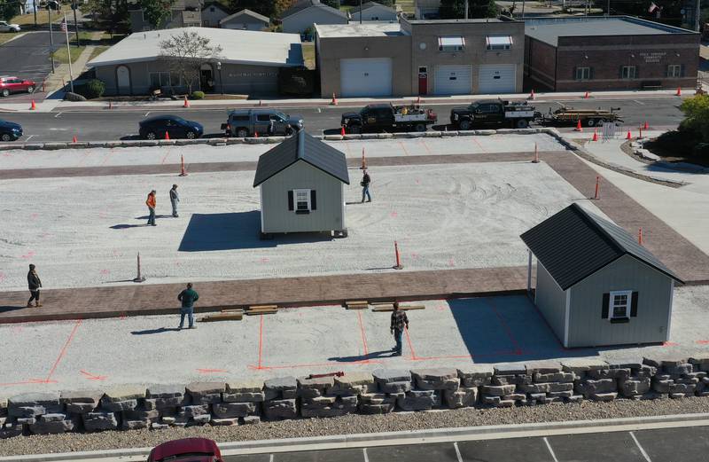 Crews move huts into the retail site plaza on Wednesday, Oct. 16, 2024 downtown Utica.