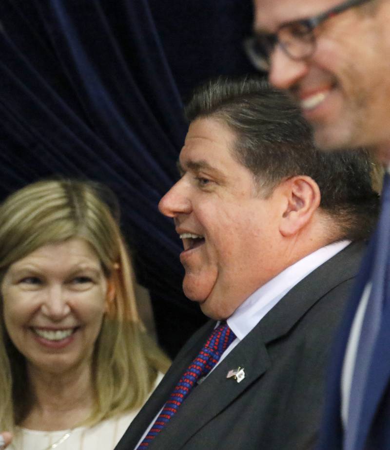 Illinois Governor JB Pritzker meets with others in attendance waiting for President Joe Biden's visit to McHenry County College on Wednesday, July 7, 2021 in Crystal Lake.