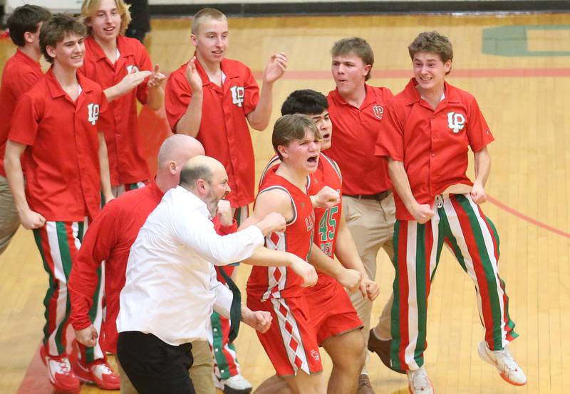 L-P head coach John Senica and the rest of the Cavalier bench react after beating Dixon during the Class 3A Regional semifinal game on Wednesday, Feb. 26, 2025 in Sellett Gymnasium at L-P High School.