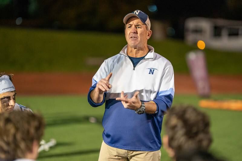 Nazareth Academy's head coach Tim Racki talks to his team after a win against Benet Academy at Benedictine University in Lisle on Friday, Oct 21, 2022.