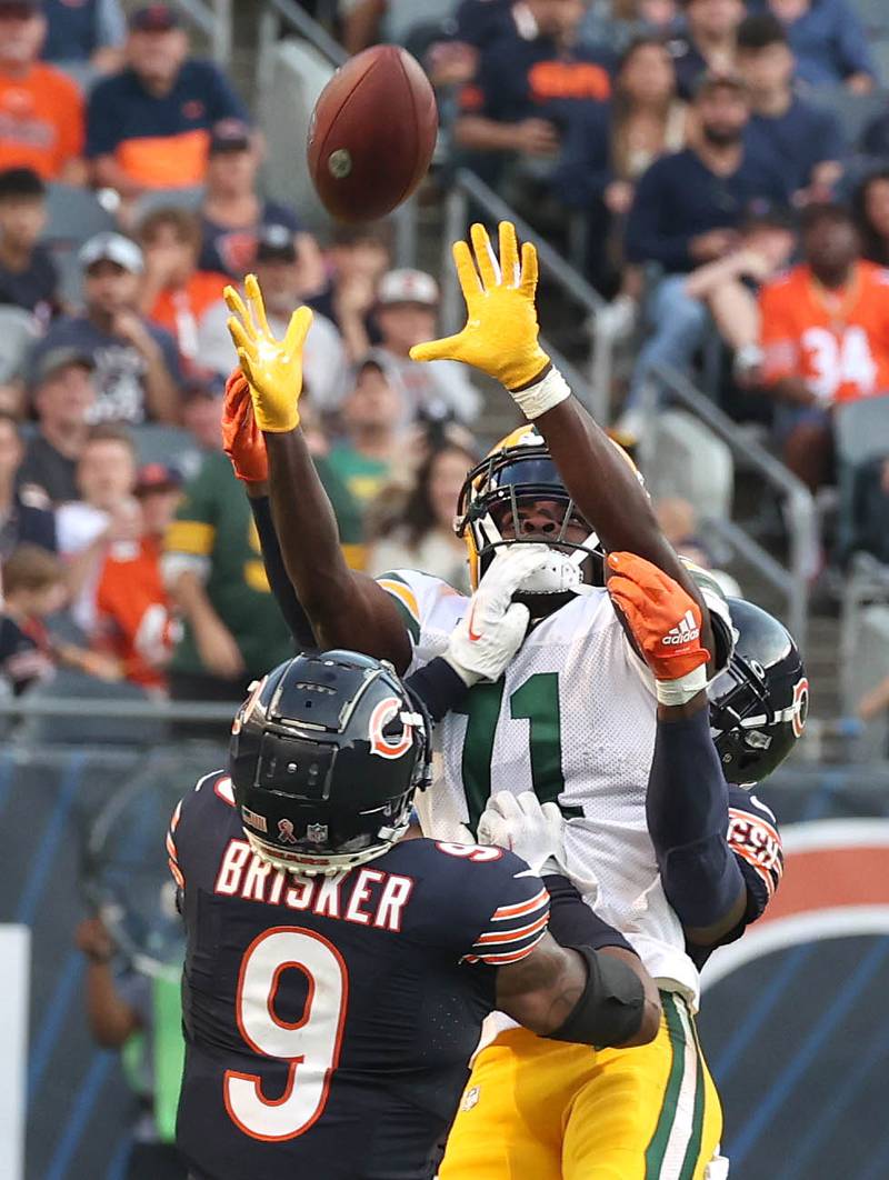 Chicago Bears safety Eddie Jackson and safety Jaquan Brisker break up a pass intended for Green Bay Packers wide receiver Jayden Reed during their game Sunday, Sept. 10, 2023, at Soldier Field in Chicago.