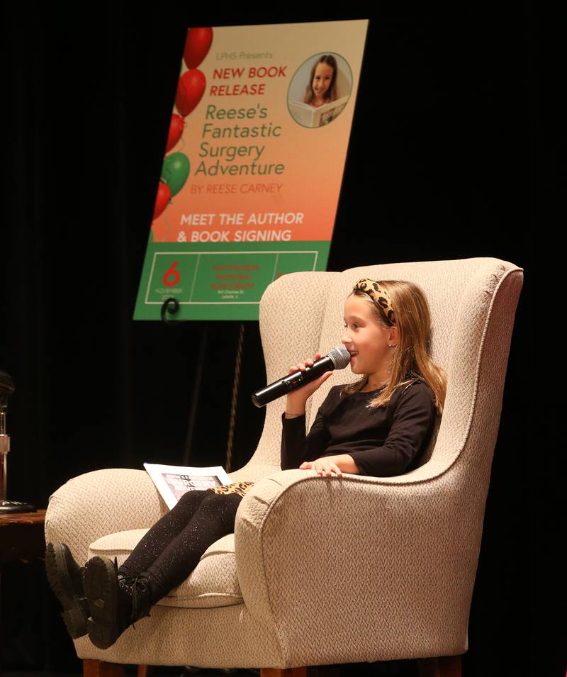 Author Reese Carney of Utica (right), talks about writing her book titled "Reeses Fantastic Surgery Adventure" during a new book release party on Monday, Nov. 6, 2023 in Matthiessen Auditorium at La Salle-Peru Township High School.