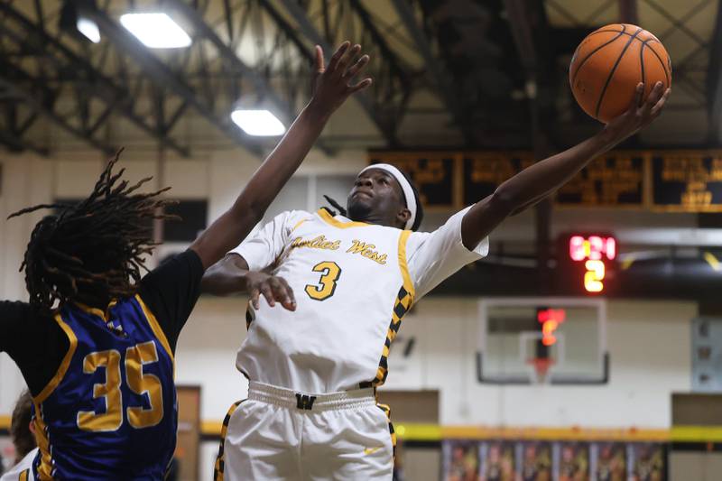 Joliet West’s Deven Triplett finesses a shot against Joliet Central on Tuesday, Feb. 17, 2026 in Joliet.