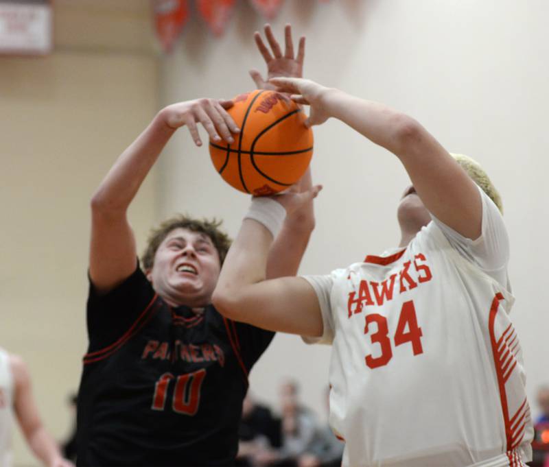 Erie-Prophetstown's Evan Steimle (10) and Oregon's Kade Girton (34) battle for the ball during Monday, Feb. 24, 2025 2A regional action at the Blackhawk Center in Oregon.