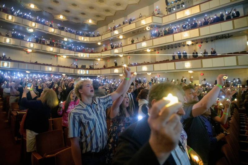 People hold candles and sing during a memorial and prayer vigil for Charlie Kirk at the John F. Kennedy Memorial Center for the Performing Arts, Sunday, Sept. 14, 2025, in Washington. (AP Photo/Rod Lamkey, Jr.)