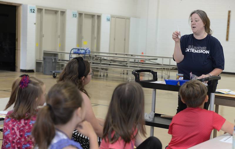 Shasta Hladovcak, of the University of Illinois Extension office, speaks to the young chefs Friday, June 30, 2023, during the Illinois Junior Chefs class at Northlawn Junior High School in Streator.