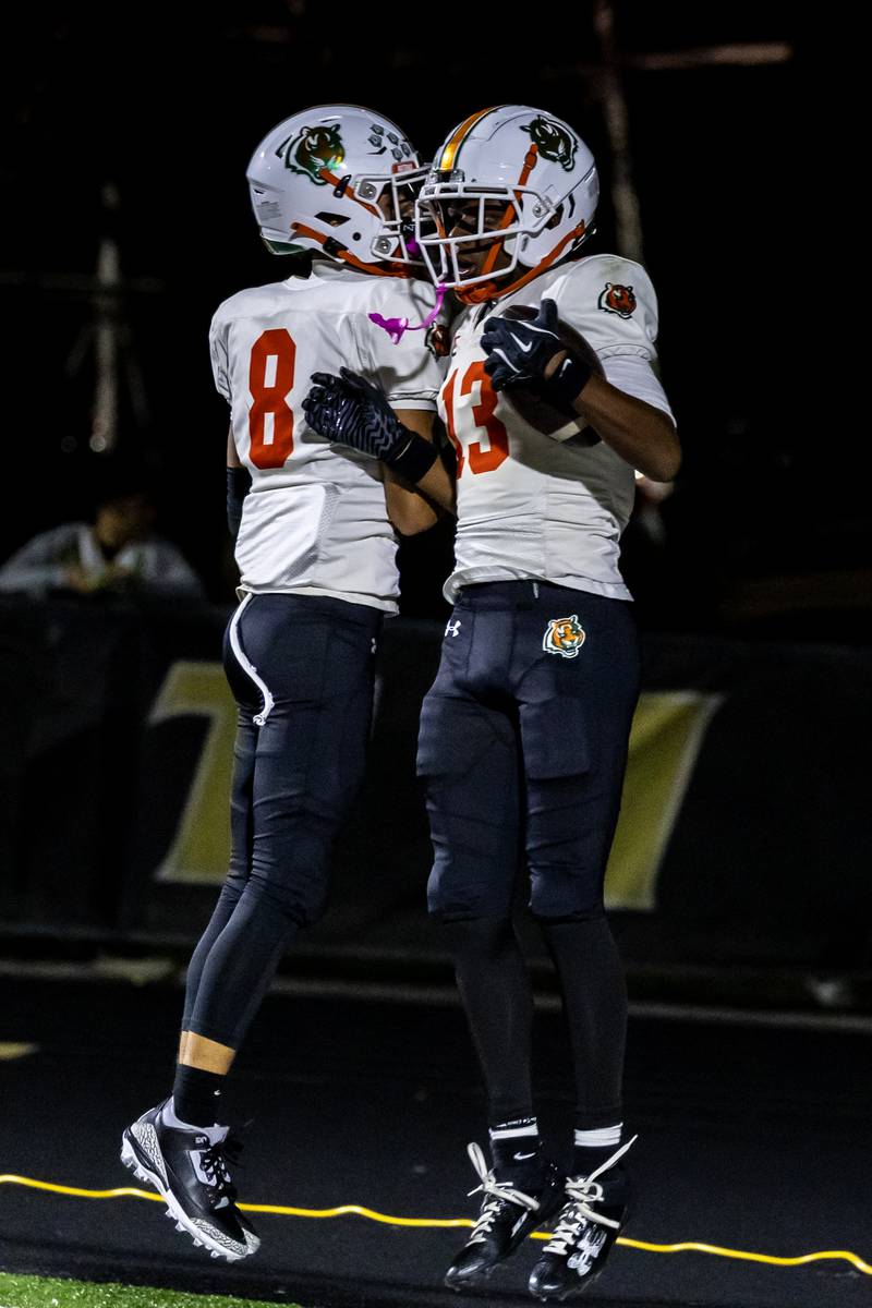 Plainfield East's Trevor Manuel celebrates with Markeith Taylor after Taylor scored a touchdown during a varsity football game against Joliet West at Joliet West on Oct. 10, 2025.
