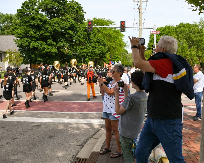 Spectators record the High School Marching band during the Memorial Day parade downtown DeKalb Monday May 30th.