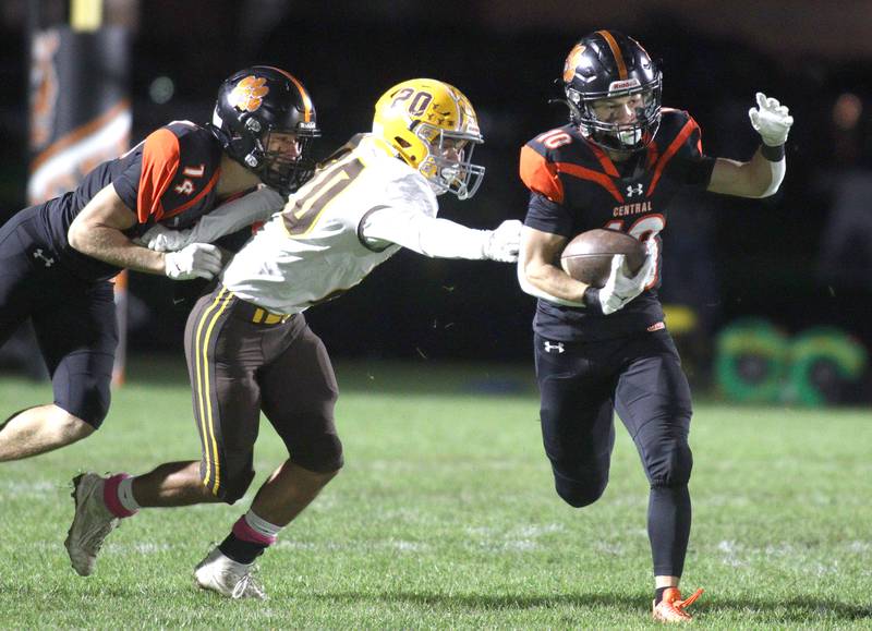 Crystal Lake Central’s Griffin Buehler, right, gets past  Jacobs’  Owen Hoffman, center, as Crystal Lake Central’s George Dimopoulos, left, defends in varsity football at Metcalf Field on the campus of Crystal Lake Central Friday night.