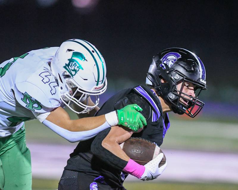 Downers Grove North's Oliver Thulin, right, carries the ball for some yards before being brought down by York's Tommy Hosler (44) during the game on Friday Oct. 10, 2025, held at Downers Grove North High School.