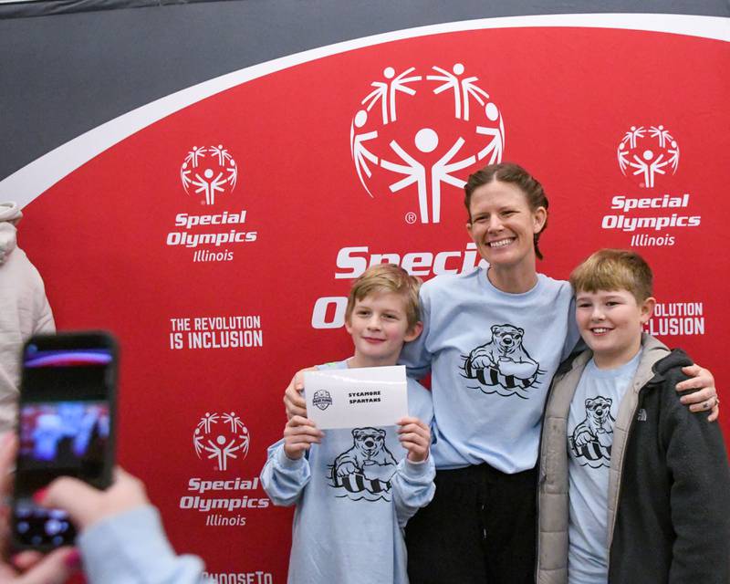 (From left) Archer Tadie, 10, Jess Johnson, and Weston Johnson, 10, of Sycamore, pose for a photo on Saturday, Feb. 15, 2025, before partaking in the 2nd annual Polar Plunge at Northern Illinois University's Huskie Stadium in DeKalb. Proceeds benefited the law enforcement torch run for Special Olympics.