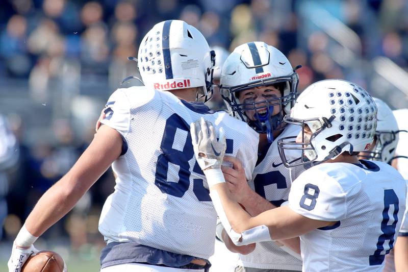 Cary-Grove’s Luca Vivaldelli, left, is greeted in the end zone after a touchdown reception against Highland Park in second-round IHSA Class 6A playoff action at Wolters Field in Highland Park Saturday.