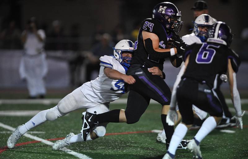 Rolling Meadows’ Devin Owen is tackled by Vernon Hills’ Gio Urso in a football game in Rolling Meadows on Friday, September 9, 2022.