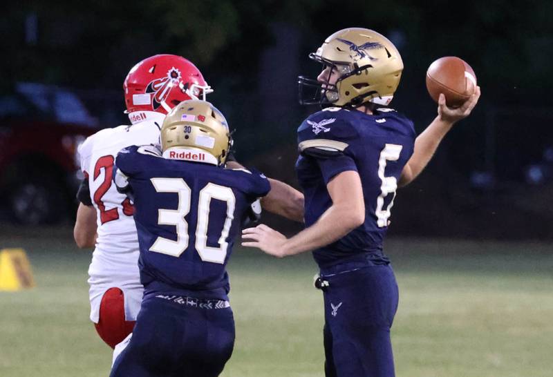 Hiawatha's Aiden Cooper gets the pass off just ahead of the South Beloit pressure during their game Friday, Sept. 20, 2024, at Hiawatha High School in Kirkland.