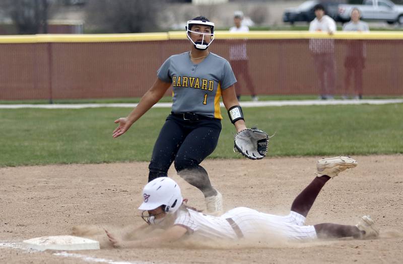 Richmond-Burton's Jocelyn Hird slides into third as Harvard's Nayeli Sanchez covers the base during a Kishwaukee River Conference softball game on Thursday, April 9, 2026, at Richmond-Burton High School.