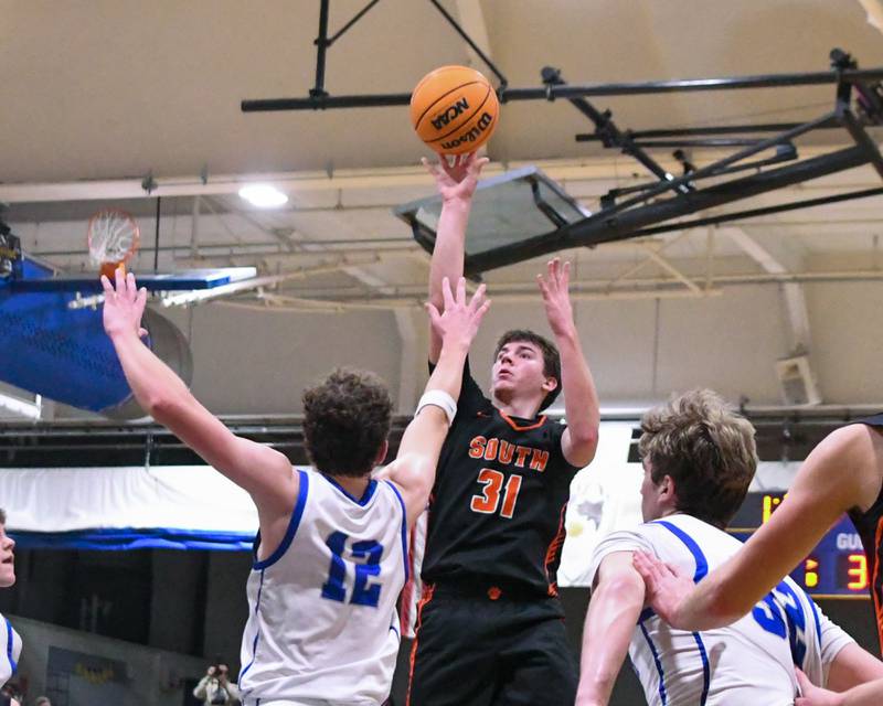 Wheaton Warrenville South's AJ Rogers (31) makes a basket while being defended by Wheaton North's Zander Zielinski (12) during the game on Friday Feb. 6, 2026, held at Wheaton North High School.