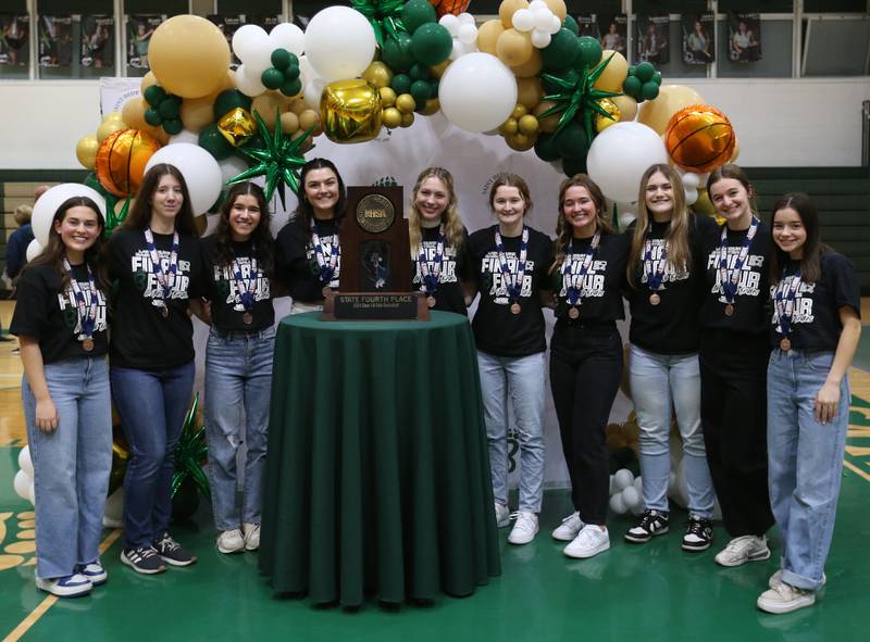 Members of the St. Bede girls basketball team pose with the Class 1A fourth-place trophy during a celebration ceremony on Tuesday, March 5, 2024 in Abbot Vincent Gymnasium.