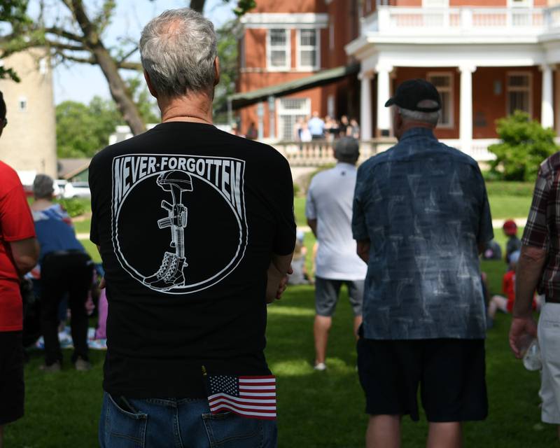 Spectators listen as members of the DeKalb High School Varsity Treble Choir sings during the Memorial Day ceremonies held on the Ellwood house lawn in DeKalb on Monday May 30th.