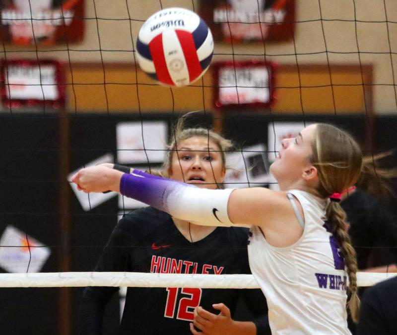 Hampshire’s Ella Ingve, front, passes the ball as Huntley’s Summer Massow keeps an eye on the action in girls varsity volleyball at Huntley High School on Thursday, October 23, 2025.