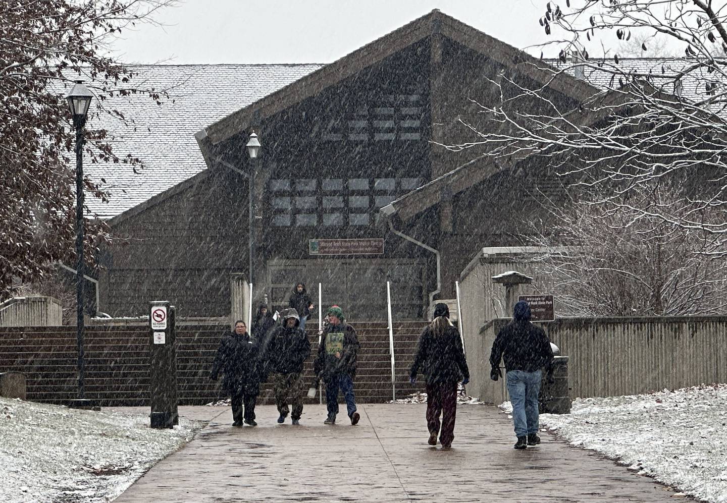 Snow falls to the ground outside the Starved Rock Visitors Center as hikers visit on Thursday, Jan. 2, 2025 at Starved Rock State Park.