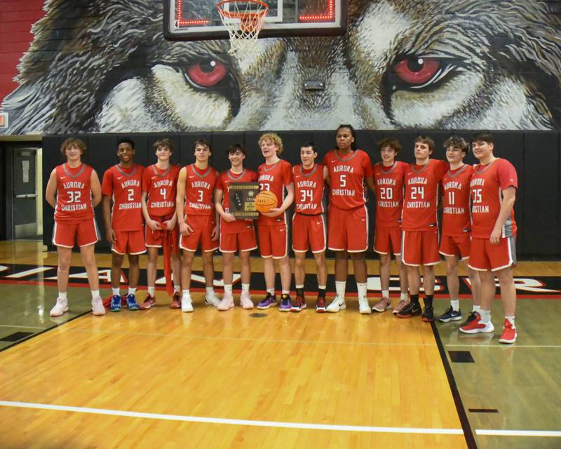 Aurora Christan basketball team pose for a photo after winning the regional title game over Yorkville Christian on Friday Feb. 28, 2025, held at Indian Creek High School.
