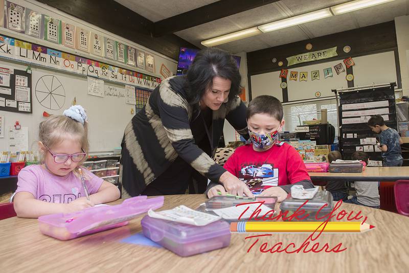 Jefferson School kindergarten teacher Melissa Heaton helps a student with his school work Thursday, April 7, 2022 at the school.