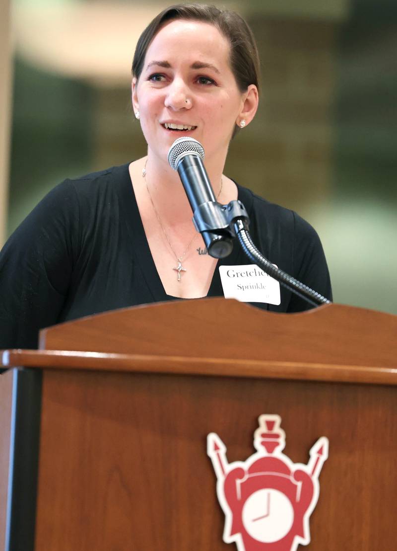 Gretchen Sprinkle speaks on behalf of Alicia Schatteman, Athena Award finalist, who was unable to attend Tuesday, Oct. 18, 2022, during the Athena and Women of Accomplishment Award reception at the Barsema Alumni and Visitors Center at Northern Illinois University in DeKalb.