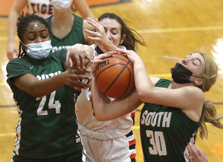 Crystal Lake South's Kree Nunnally, left, and Hanna Massie, right, battle for a rebound with  Crystal Lake Central's Paige Keller, center, during a Fox Valley Conference game Wednesday, Jan. 26, 2022, between Crystal Lake South and Crystal Lake Central at Crystal Lake Central High School.