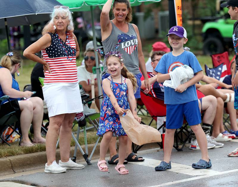 Attendees get excited as they spot the parade beginning its trip down Main Street Friday, July 4, 2025, during the Fourth of July parade in downtown Kirkland.