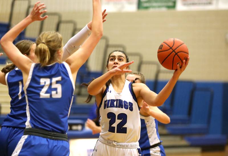 Geneva’s Leah Palmer (right) attempts a shot over Wheaton North’s Brigette Noyes during a game at Geneva on Friday, Dec. 22, 2023.