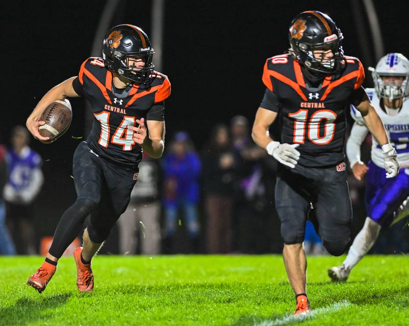 Crystal Lake Central's George Dimopoulos runs for yardage with Griffin Buehler leading the way against Fox Valley Conference rival Hampshire on Friday, Oct. 20, 2023 in Crystal Lake.