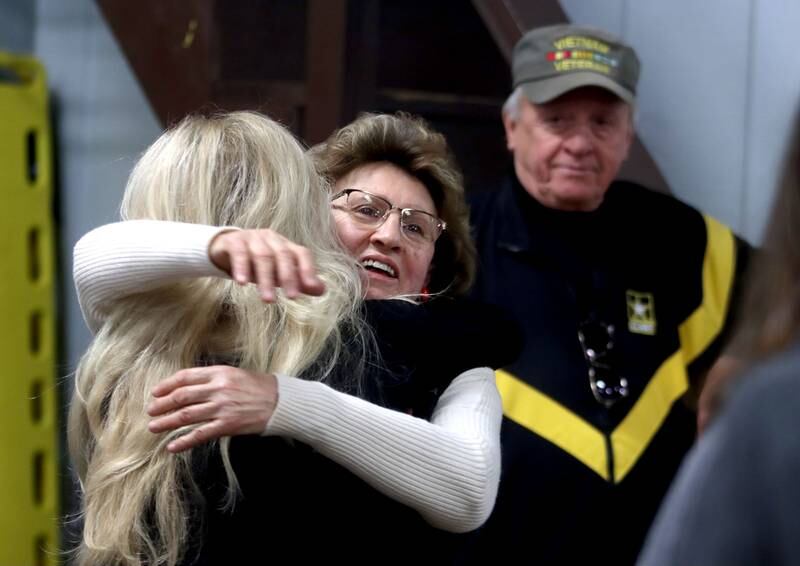 Mary Olczyk of Carol Stream, facing camera, embraces friend Lilly Franz of West Chicago as a remembrance was held Saturday at Wonder Lake Fire Protection District Station 2 on the 40th anniversary of a midair military jet explosion that happened over the small, rural area northeast of Woodstock. Olczyk’s husband Steven J Olczyk and 26 others died as the plane exploded midair, its flaming pieces raining over a 2-mile area near Greenwood.