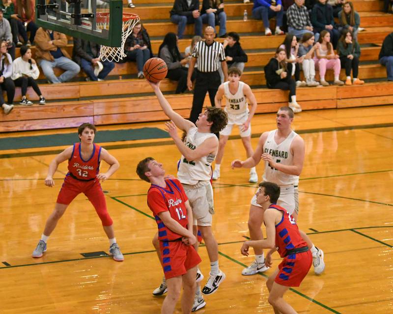 Glenbard West's Bennett Schwnanke (22) makes a shot while being defended by Glenbard South's Michell Erickson (12) during the second quarter on Monday Nov. 20, 2023, during the district 87 Invite held at Glenbard West.