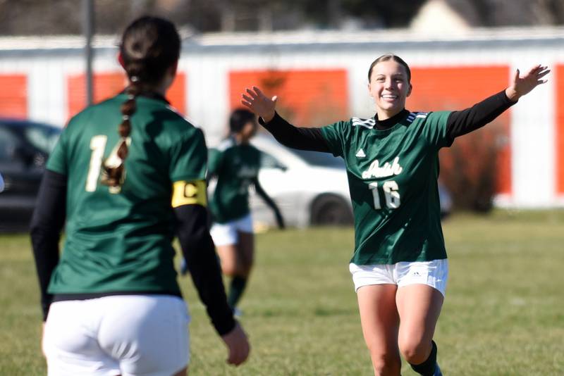 Bishop McNamara's Ava Brockell, right, rushes to congratulate teammate Ella Langellier on her goal during McNamara's home All-City game against Kankakee Saturday, March 22, 2025.