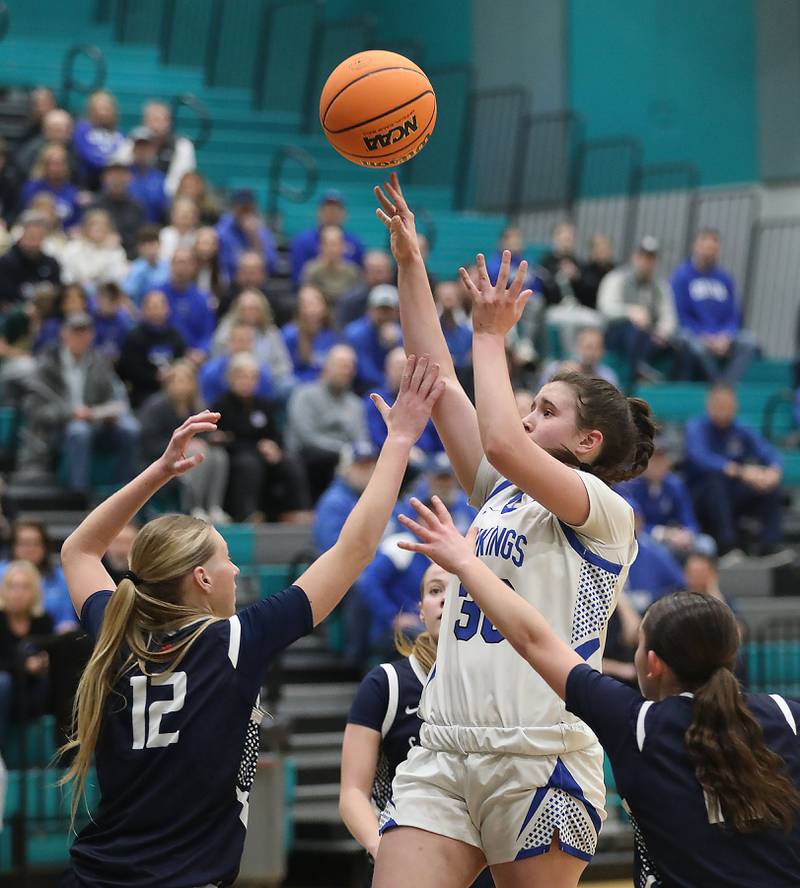 Geneva's Keira McCann (center) shoots the ball between St. Viator's Emily Walberg (left) and Bella Gounaris (right) during the IHSA Class 3A Woodstock North Supersectional girls basketball game on Monday, March 2, 2026, at Woodstock North High School.