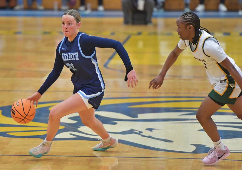Nazareth’s Lyla Shelton drives with the ball as Waubonsie Valley’s Syncere Williams (right) chases during the Class 4A Lyons Supersectional game on March 2, 2026 at Lyons Township High School in LaGrange.