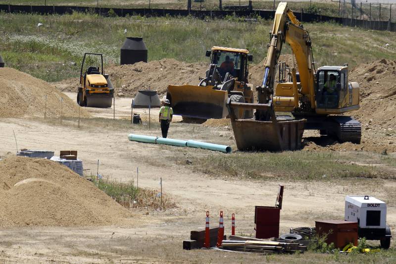 Construction equipment is seen at work during a ground breaking ceremony for a new Mercyhealth hospital at the intersection of Three Oaks Road and Rt. 31 on Wednesday, June 16, 2021 in Crystal Lake.