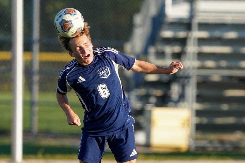Oswego East's Dillan Max (6) heads the ball during a Southwest Prairie Conference game against Oswego at Oswego East High School on Thursday, Sept. 25, 2025.