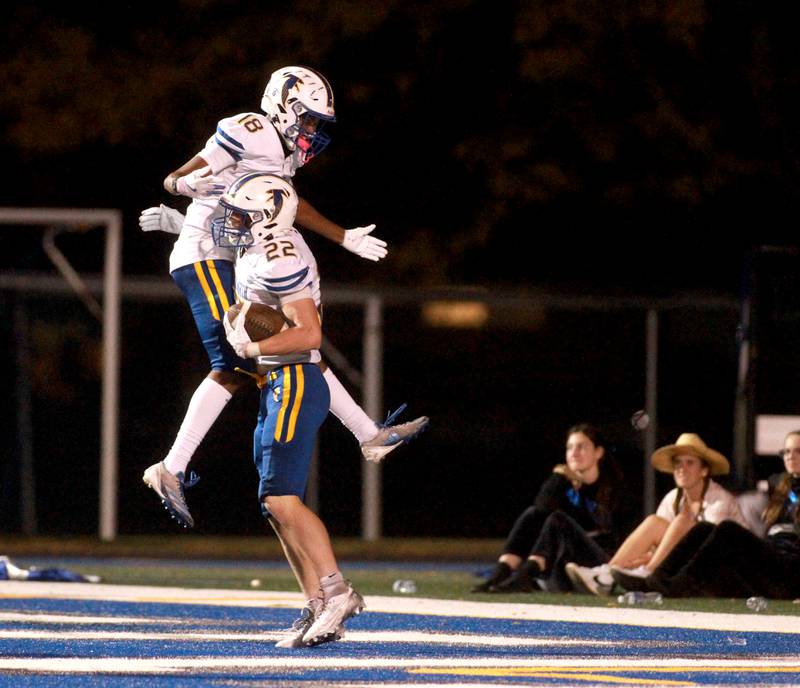 Wheaton North’s Simon Kahsay (left) and Nik Schaafsma celebrate Schaafsma’s touchdown during a game against Wheaton North on Friday, Oct. 11, 2024 at Geneva.