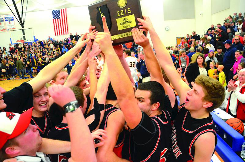 The Forreston Cardinals hold up the Eastland Sectional Championship Friday night after defeating Aquin 59-58. Photo by Chris Johnson