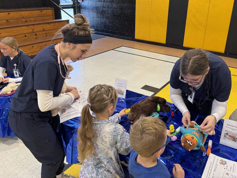 Grundy Area Vocational Center students help a Nettle Creek Elementary student conduct a check-up on their stuffed animal.
